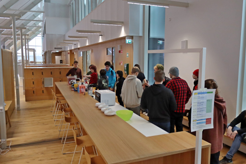 People gathering for snacks at Games Co-op event.